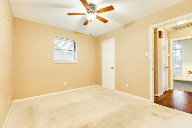 spare room with hardwood / wood-style floors and ceiling fan