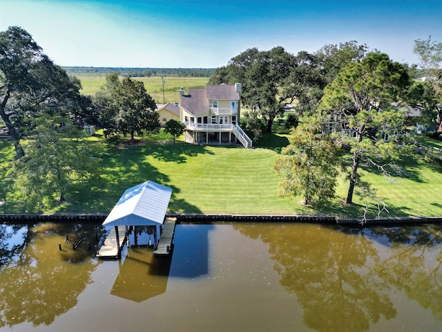 dock area with a yard and a deck with water view