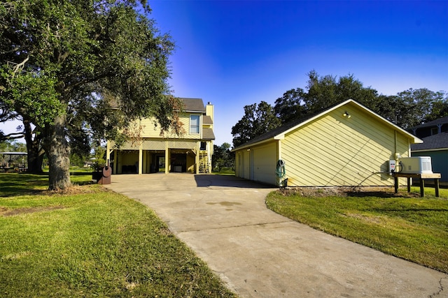 view of side of home with a yard