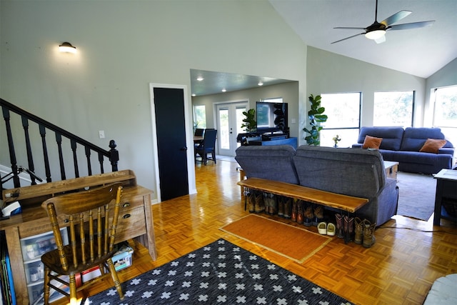 living room with parquet flooring, high vaulted ceiling, and a healthy amount of sunlight