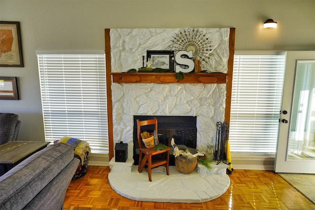 living room featuring a fireplace and parquet flooring