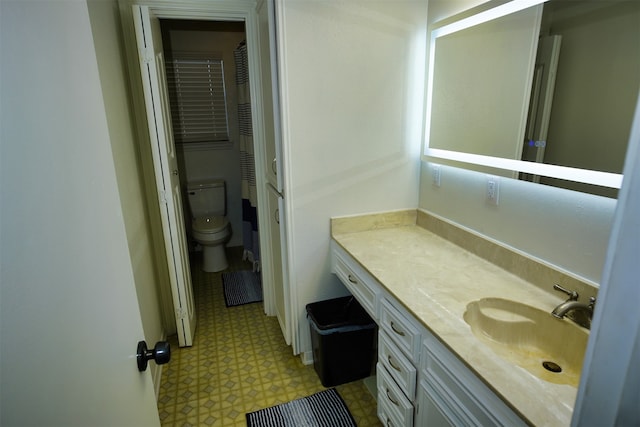 bathroom featuring vanity and toilet