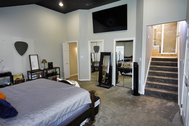 bedroom with carpet floors and high vaulted ceiling