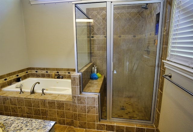 bathroom with separate shower and tub and tile patterned floors