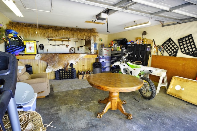 garage featuring white refrigerator and a garage door opener