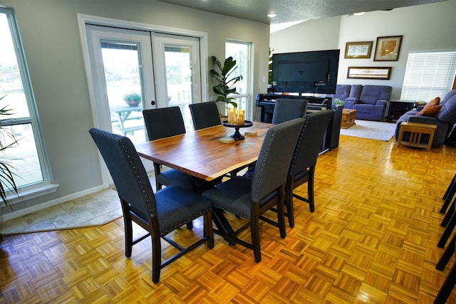 dining space featuring french doors, a textured ceiling, and light parquet floors