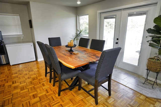 dining space with light parquet flooring