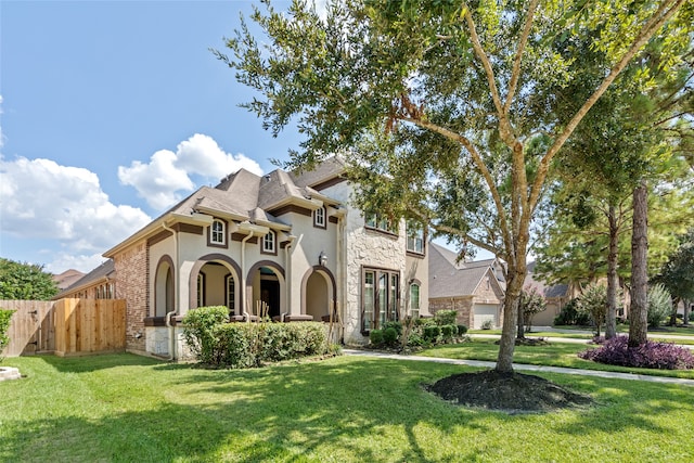 view of front of property with a front lawn and french doors