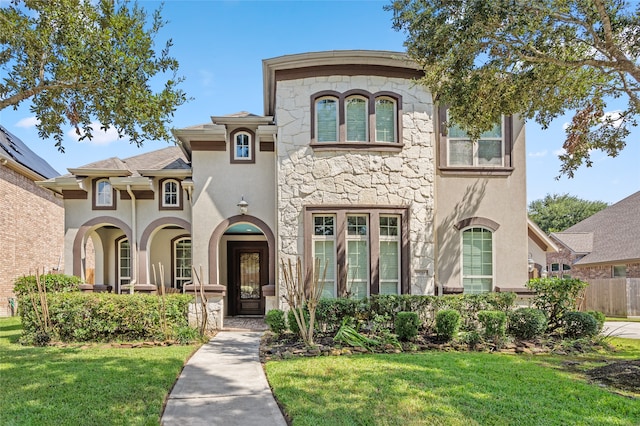 view of front of house with a front yard and french doors