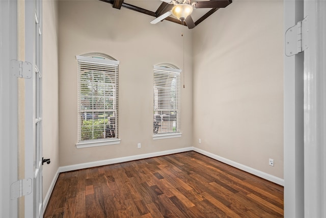 spare room with dark wood-type flooring and ceiling fan