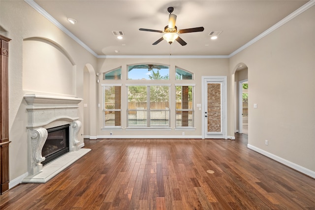 unfurnished living room featuring ceiling fan, a fireplace, crown molding, and dark hardwood / wood-style flooring