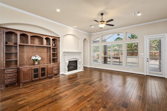 unfurnished living room with ceiling fan, a fireplace, crown molding, and dark hardwood / wood-style flooring