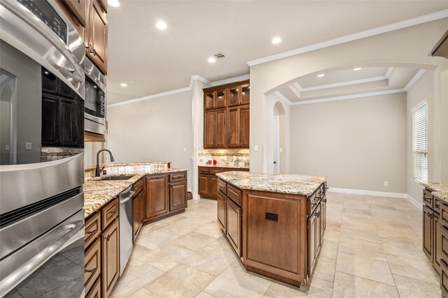 kitchen featuring ornamental molding, appliances with stainless steel finishes, sink, and tasteful backsplash