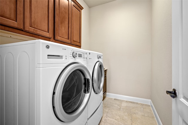 washroom with separate washer and dryer and cabinets