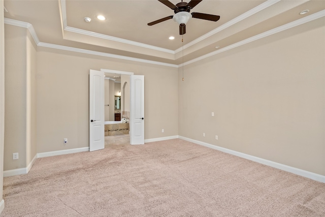 spare room featuring ornamental molding, ceiling fan, a raised ceiling, and carpet floors