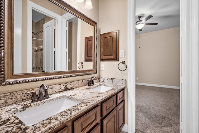 bathroom featuring a tile shower, ceiling fan, and vanity