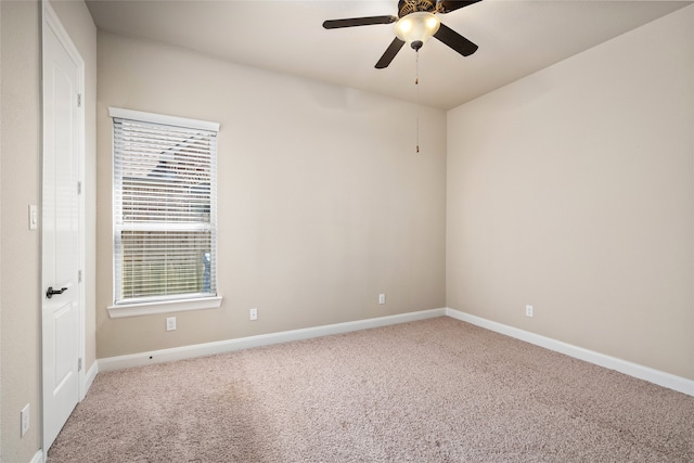 carpeted spare room featuring ceiling fan