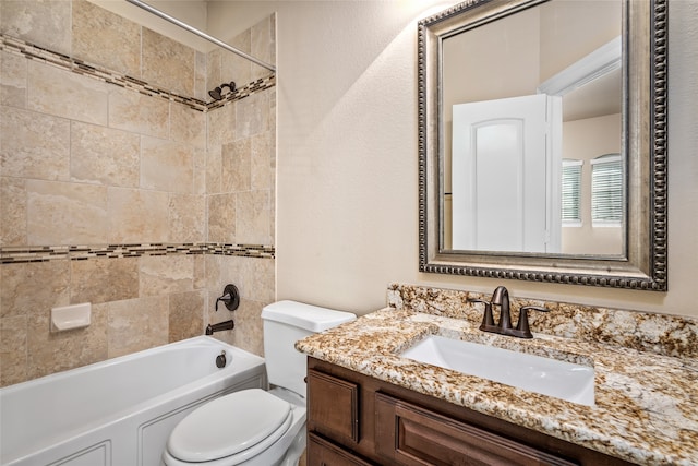 full bathroom with tiled shower / bath combo, vanity, and toilet