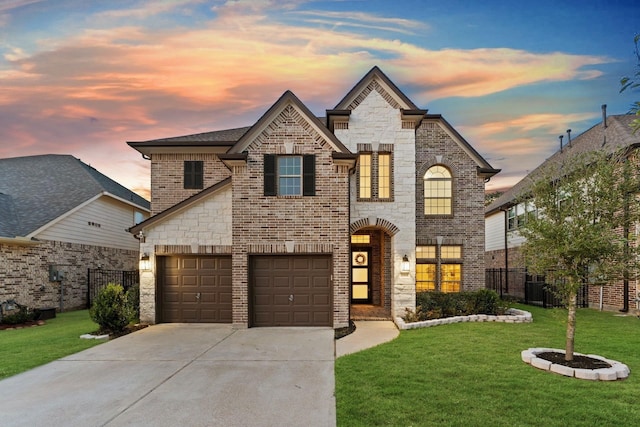 view of front of property with a yard and a garage