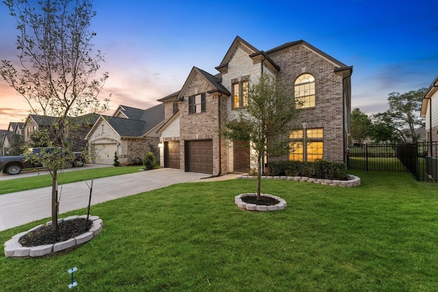 view of front of property with a garage and a yard