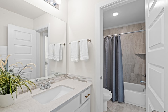 full bathroom featuring shower / bath combo, vanity, and toilet