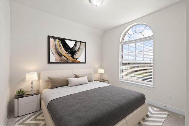 carpeted bedroom featuring multiple windows