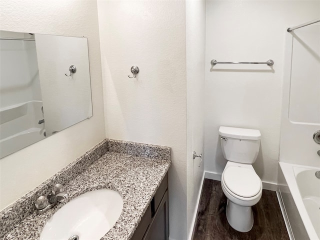 full bathroom featuring bathtub / shower combination, vanity, hardwood / wood-style floors, and toilet