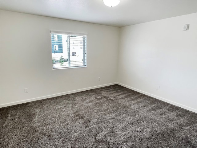 empty room featuring dark carpet