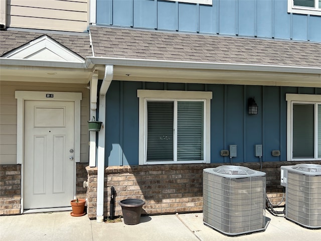 view of exterior entry with central air condition unit