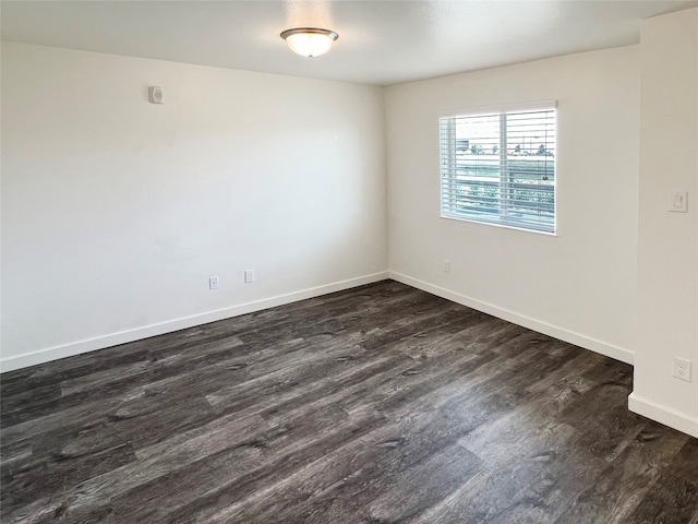 unfurnished room with dark hardwood / wood-style flooring