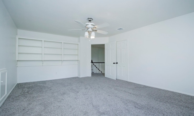 spare room featuring carpet floors and ceiling fan