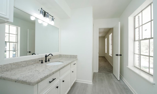 bathroom featuring hardwood / wood-style flooring and vanity