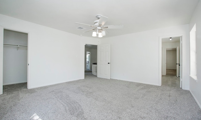 unfurnished bedroom featuring ceiling fan, a closet, and carpet