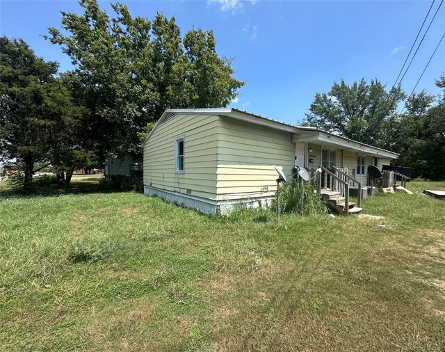 view of property exterior featuring a lawn