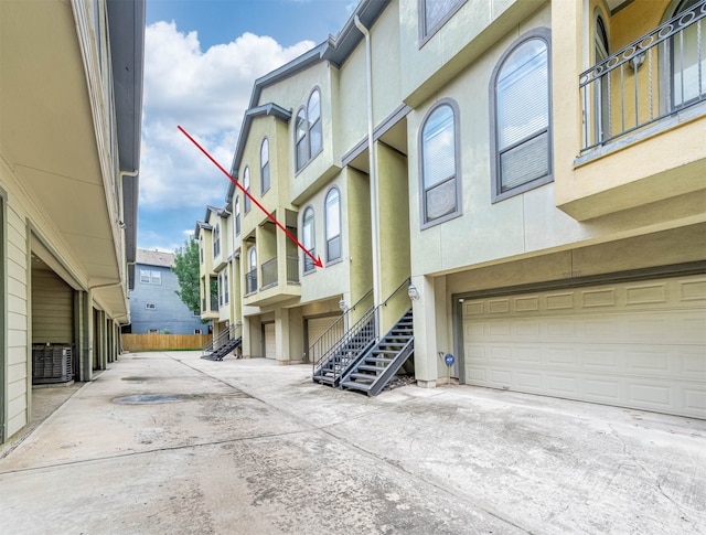 exterior space featuring a garage and central air condition unit