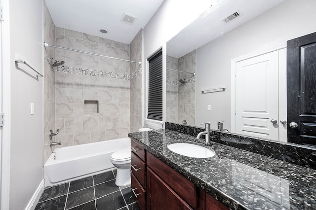 full bathroom with vanity, tiled shower / bath combo, toilet, and tile patterned flooring