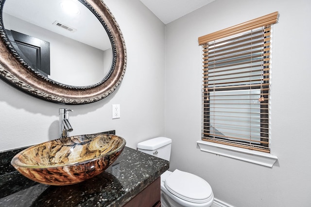 bathroom featuring vanity and toilet