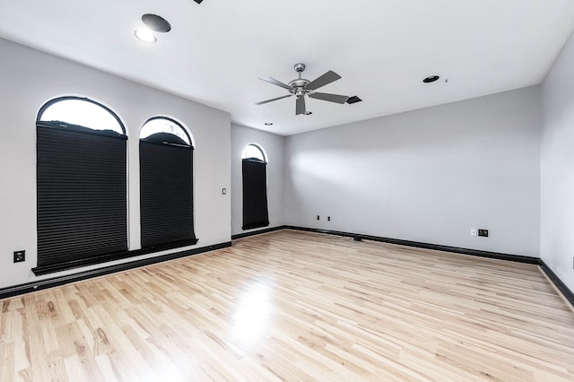 empty room with ceiling fan and light wood-type flooring