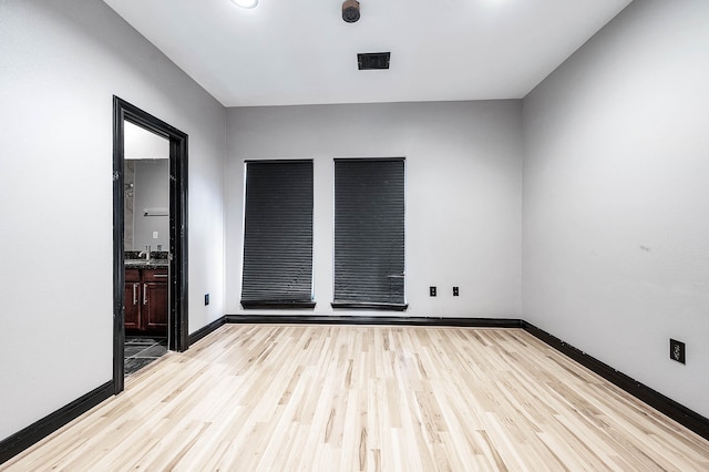 empty room featuring light hardwood / wood-style flooring and sink