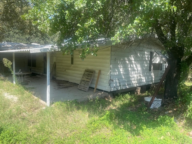 rear view of property with a carport