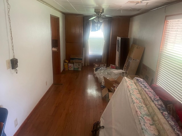 interior space with ceiling fan, dark wood-type flooring, and a wealth of natural light