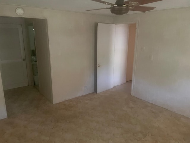 interior space with ceiling fan and light colored carpet