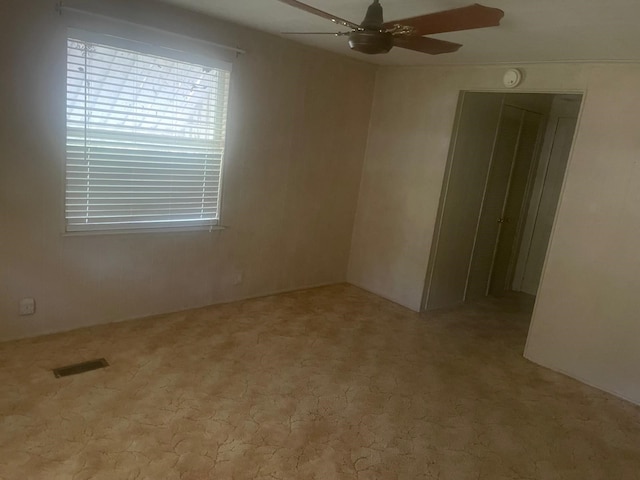 carpeted empty room with ceiling fan