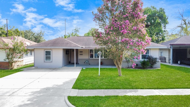 ranch-style home with a carport and a front lawn