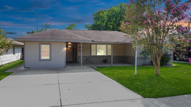 single story home featuring a yard and a carport