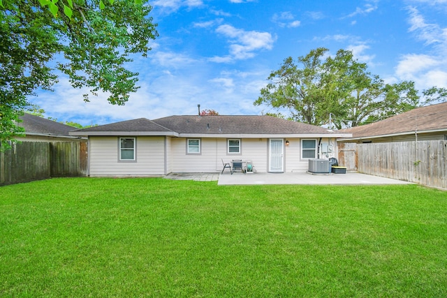 back of house with central air condition unit, a yard, and a patio