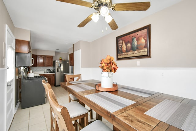 dining area with ceiling fan and light tile patterned floors