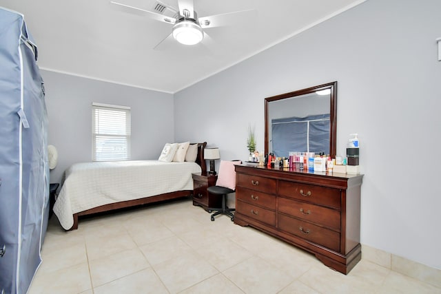 bedroom with ceiling fan and light tile patterned floors