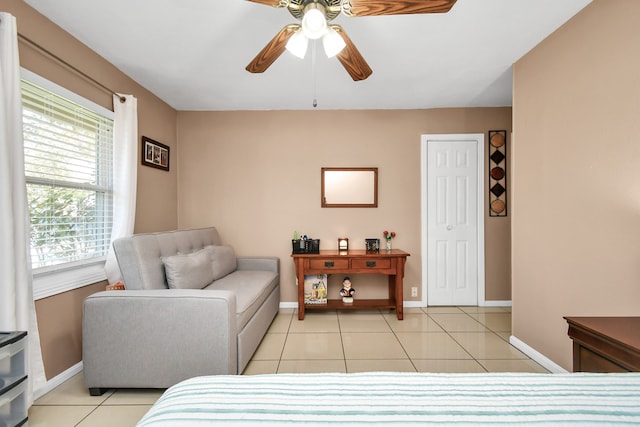 tiled bedroom featuring ceiling fan