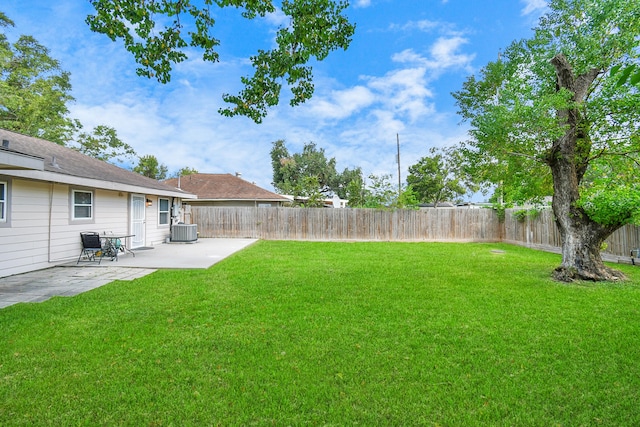 view of yard featuring cooling unit and a patio area